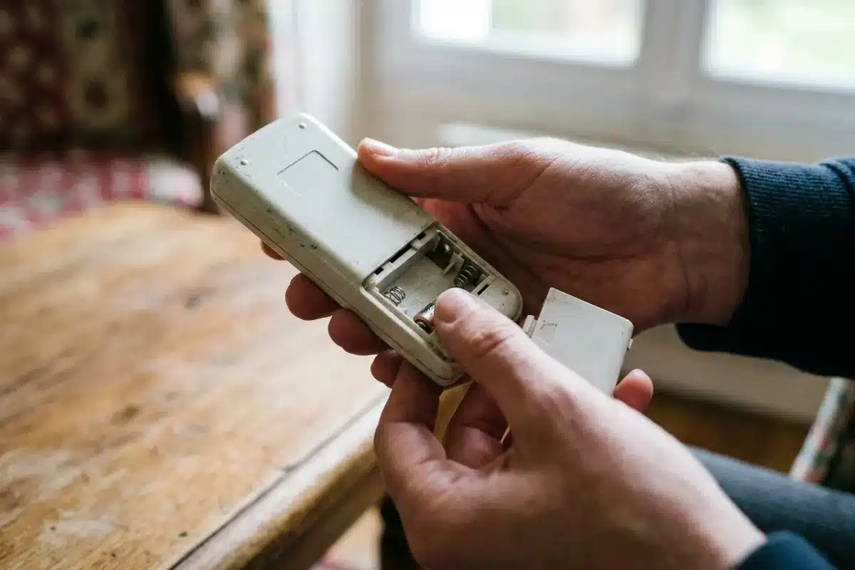 Vérification de la pile et des contacts dans une télécommande Franciaflex.